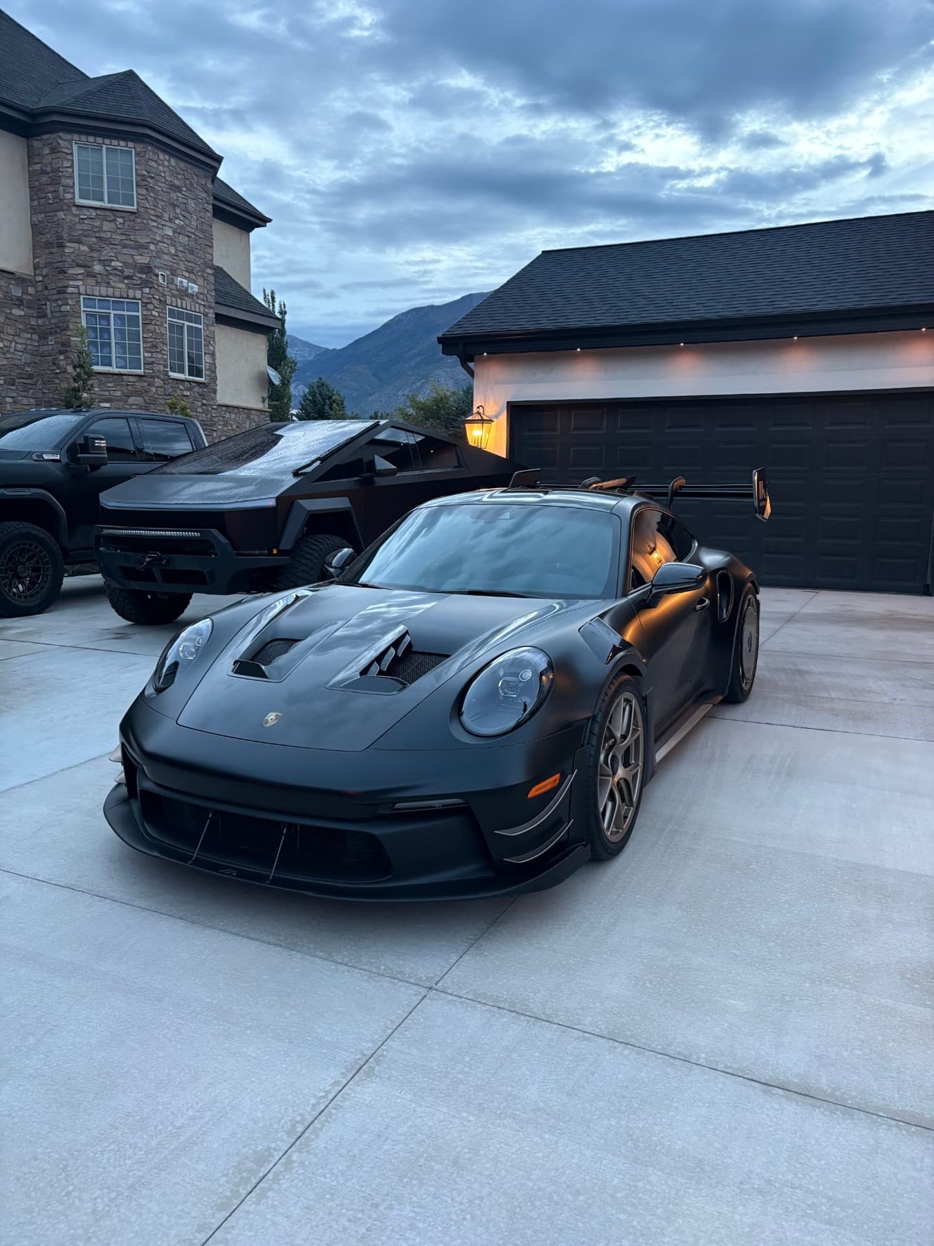 Matte black Porsche 911 GT3 RS and Cybertruck detailed at a mountain home in Park City, Utah