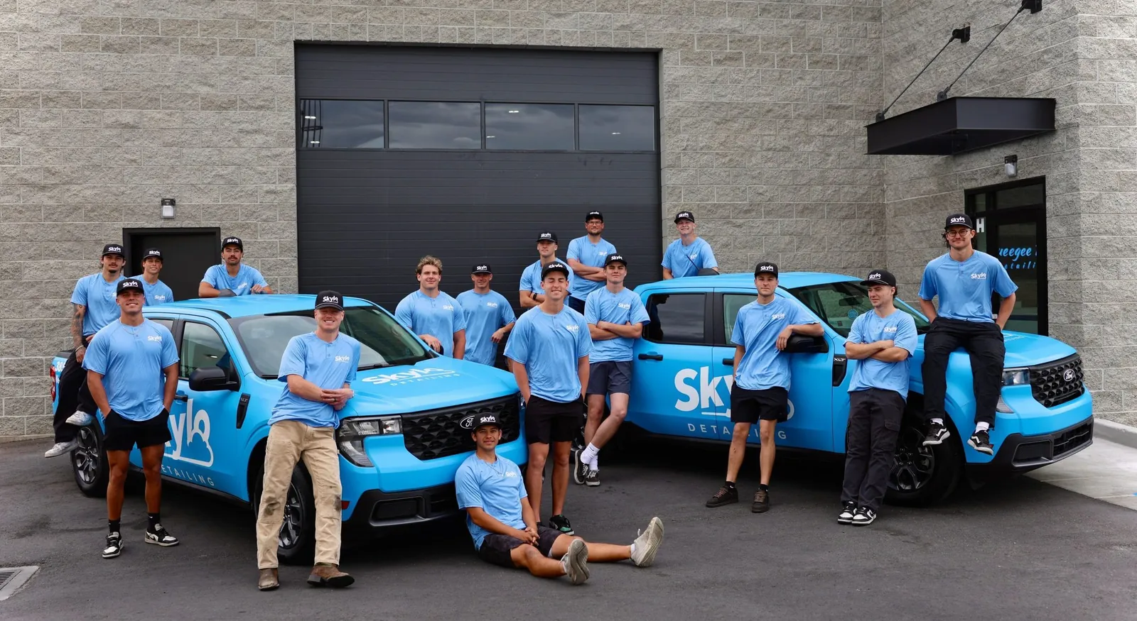 The Skylo Detailing crew in front of their service trucks